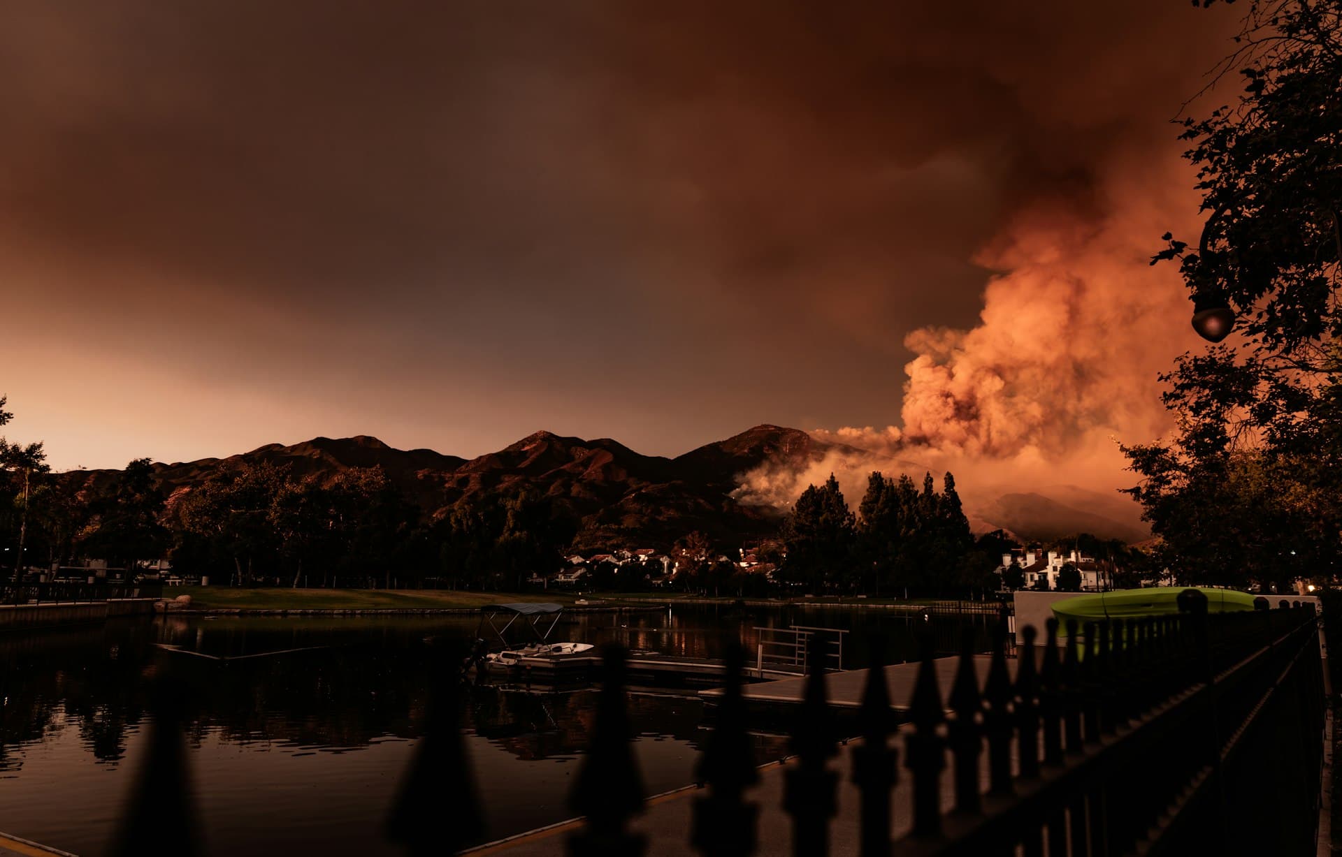 Orange County wildfire smoke plume over mountains and residential area