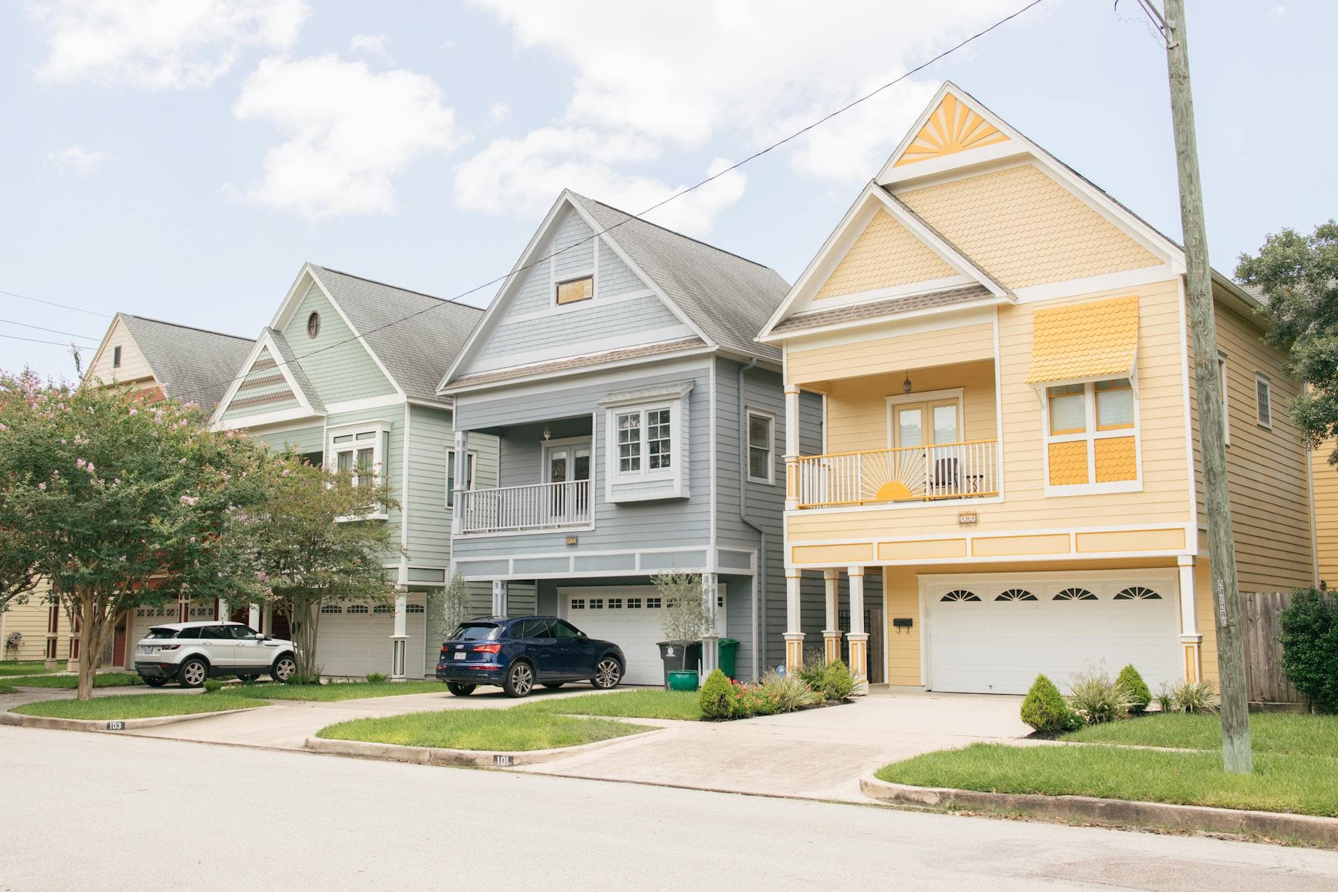 Colorful residential homes in Texas neighborhood with modern architecture and gabled roofs