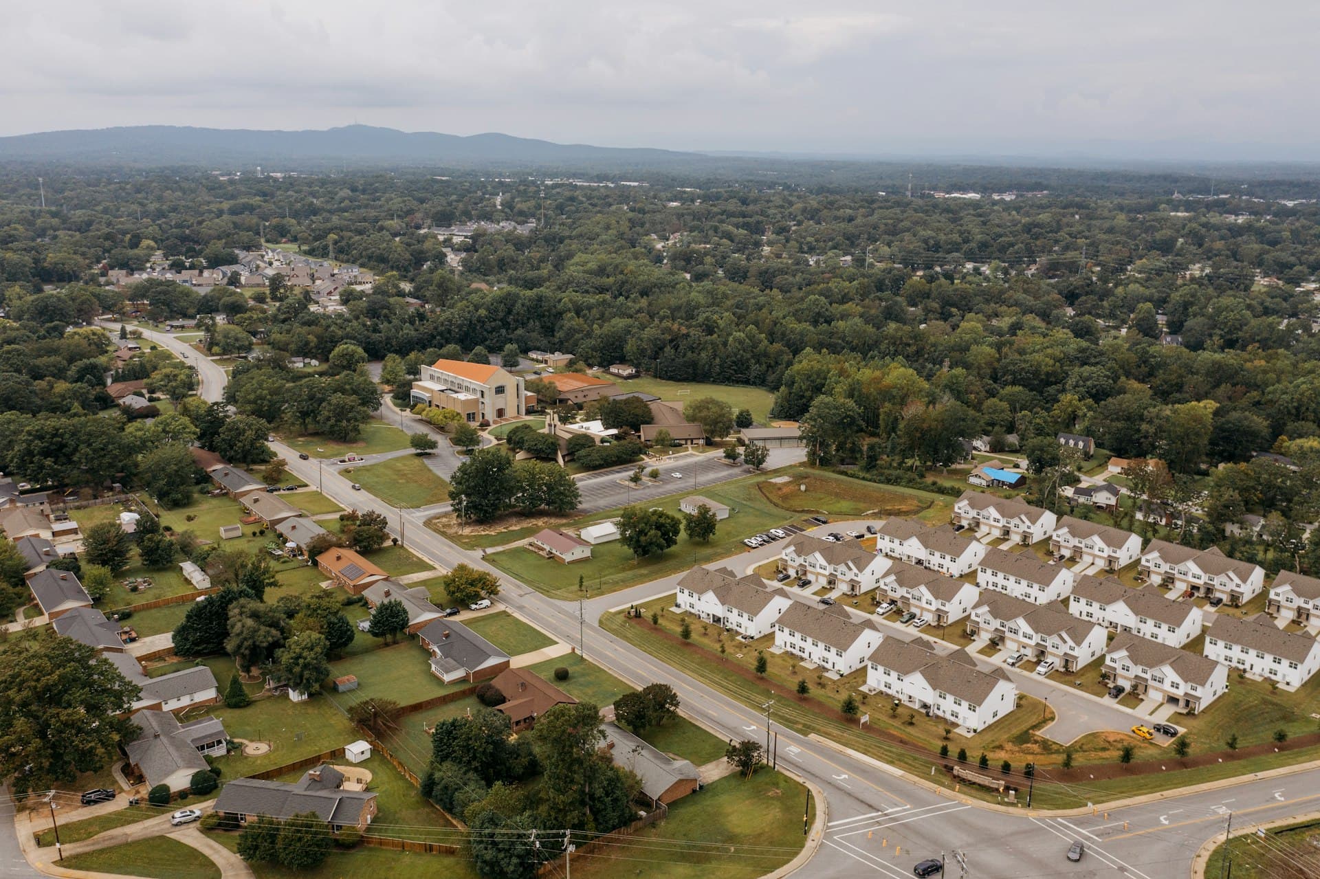 Aerial view of suburban residential neighborhood with rows of single-family homes typical of Fox Valley Aurora