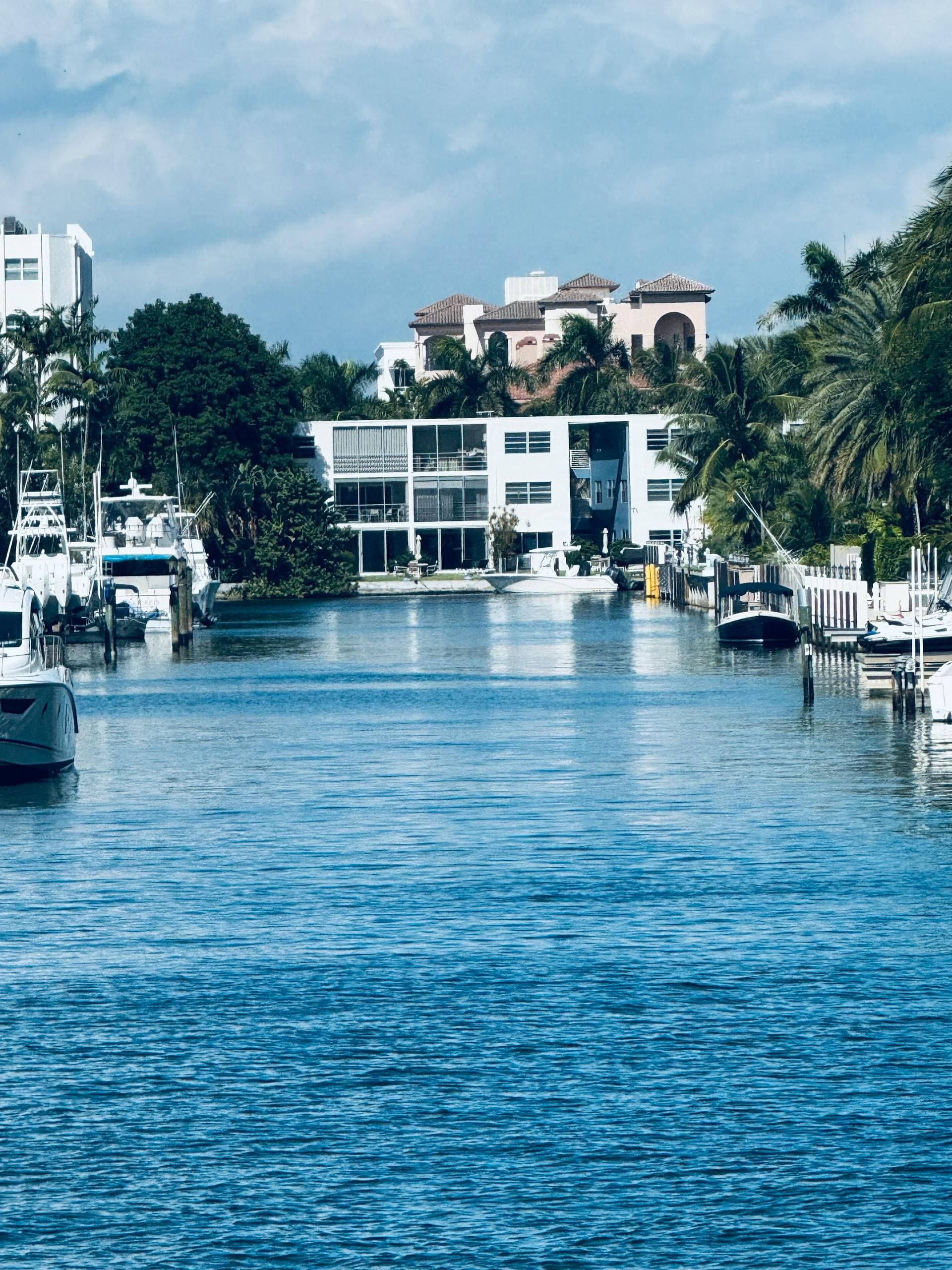 Luxury waterfront homes along Florida canal with boats