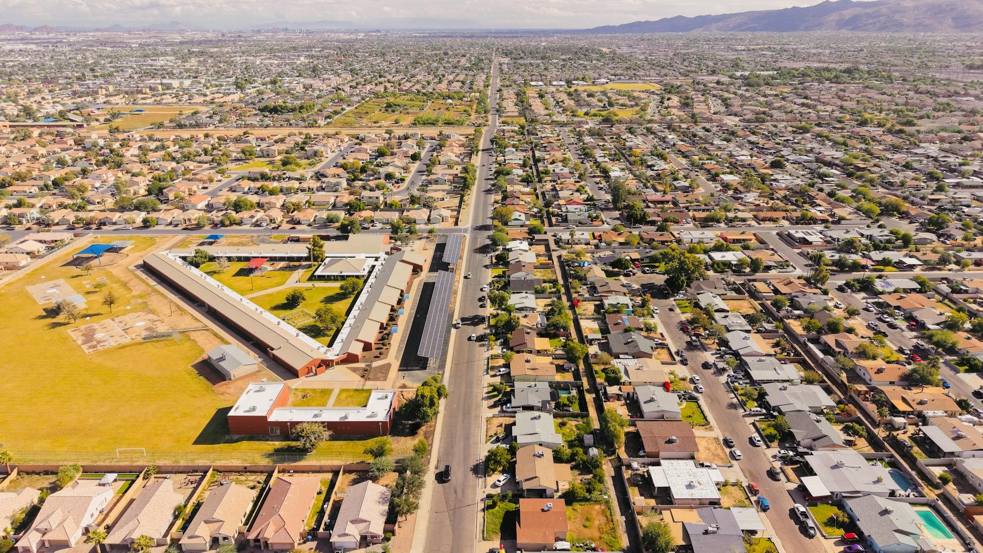 Aerial view of Arizona residential neighborhood with mountains in background