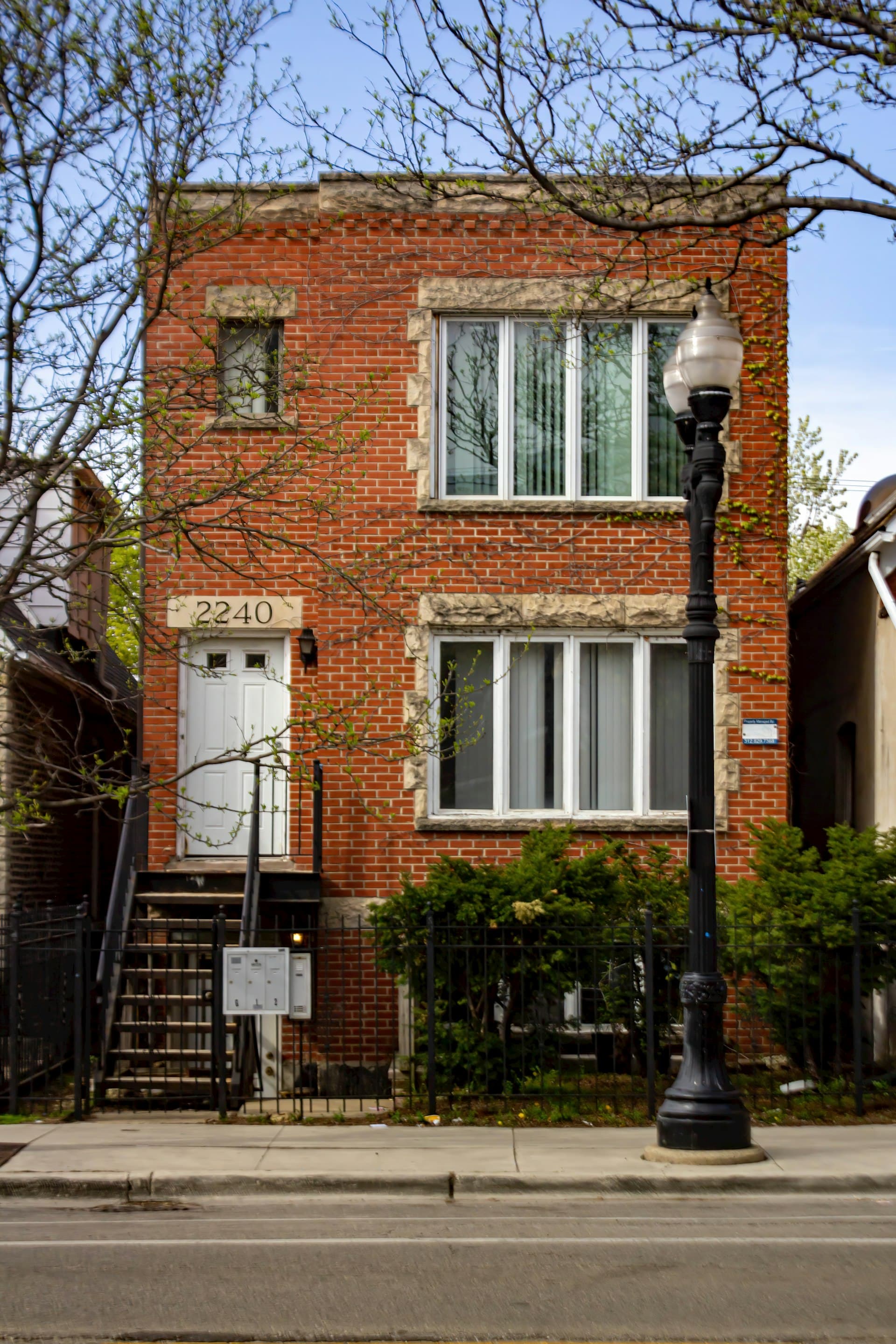 Classic Chicago red brick two-flat building with flat roof typical of city architecture