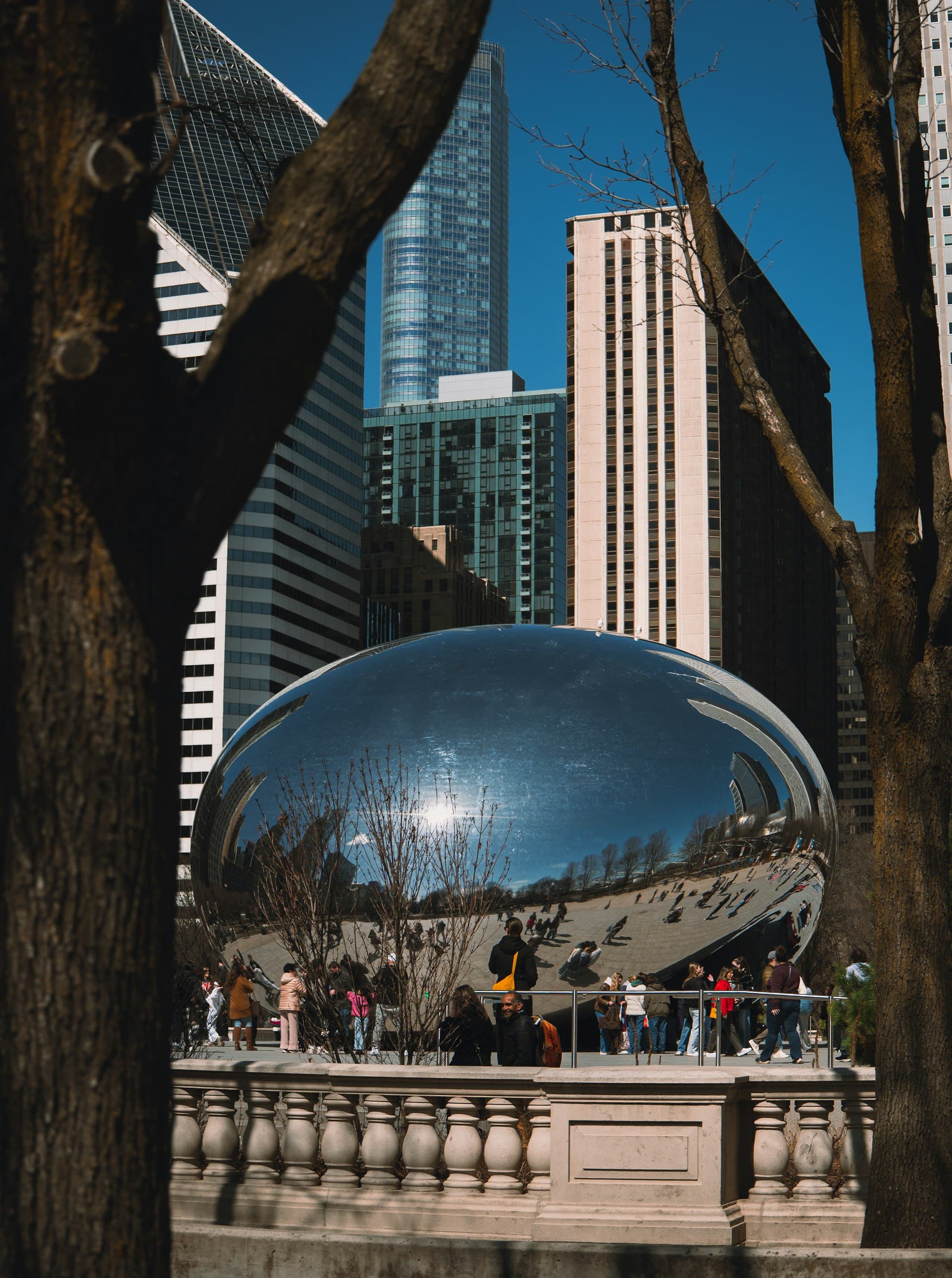 Cloud Gate sculpture known as The Bean in Millennium Park with Chicago skyline reflection