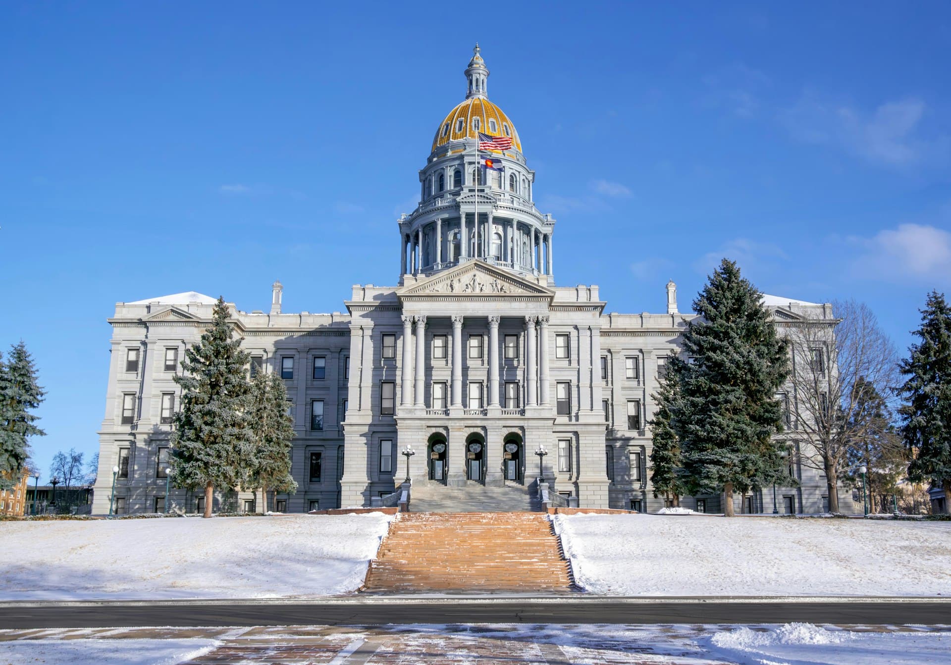 Colorado State Capitol building with golden dome in winter snow
