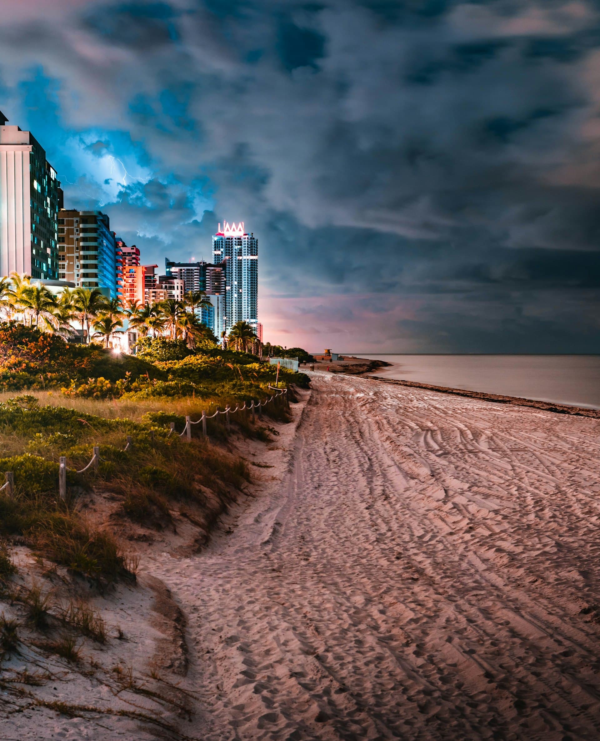 Dramatic storm clouds approaching South Florida beach with lightning before hurricane