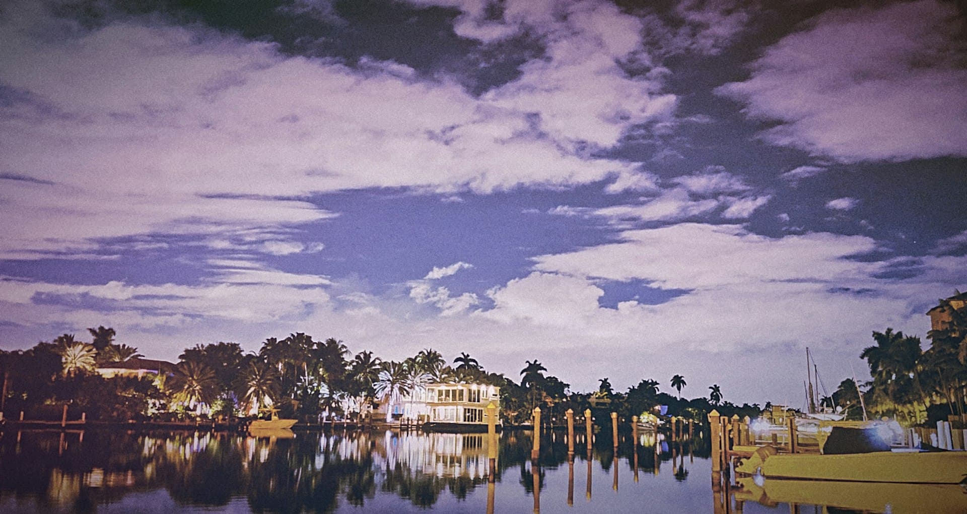 Luxury waterfront homes along Las Olas canal in Fort Lauderdale with palm trees and boat docks