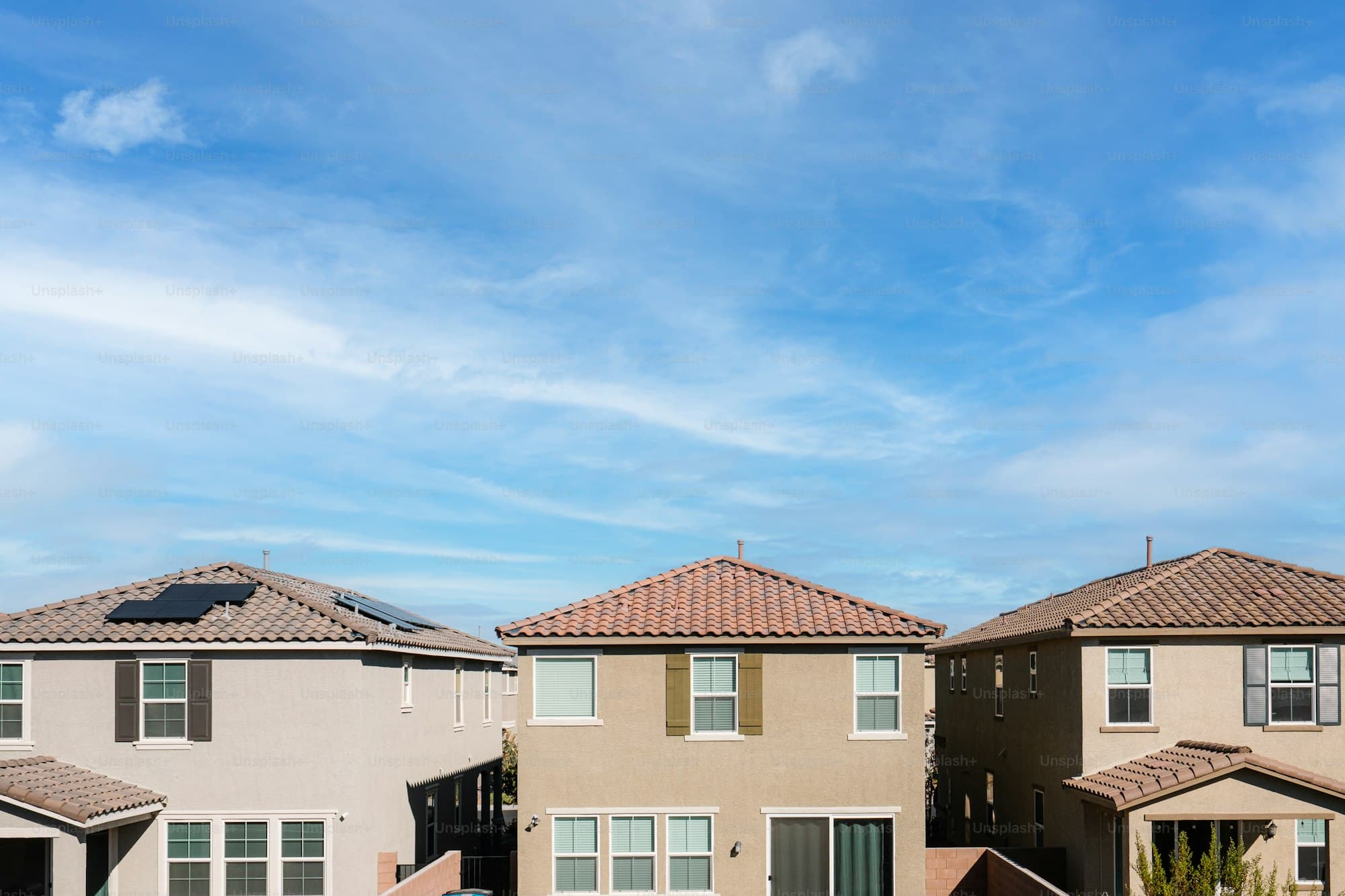 Henderson Nevada homes with tile roofs and solar panels under blue sky