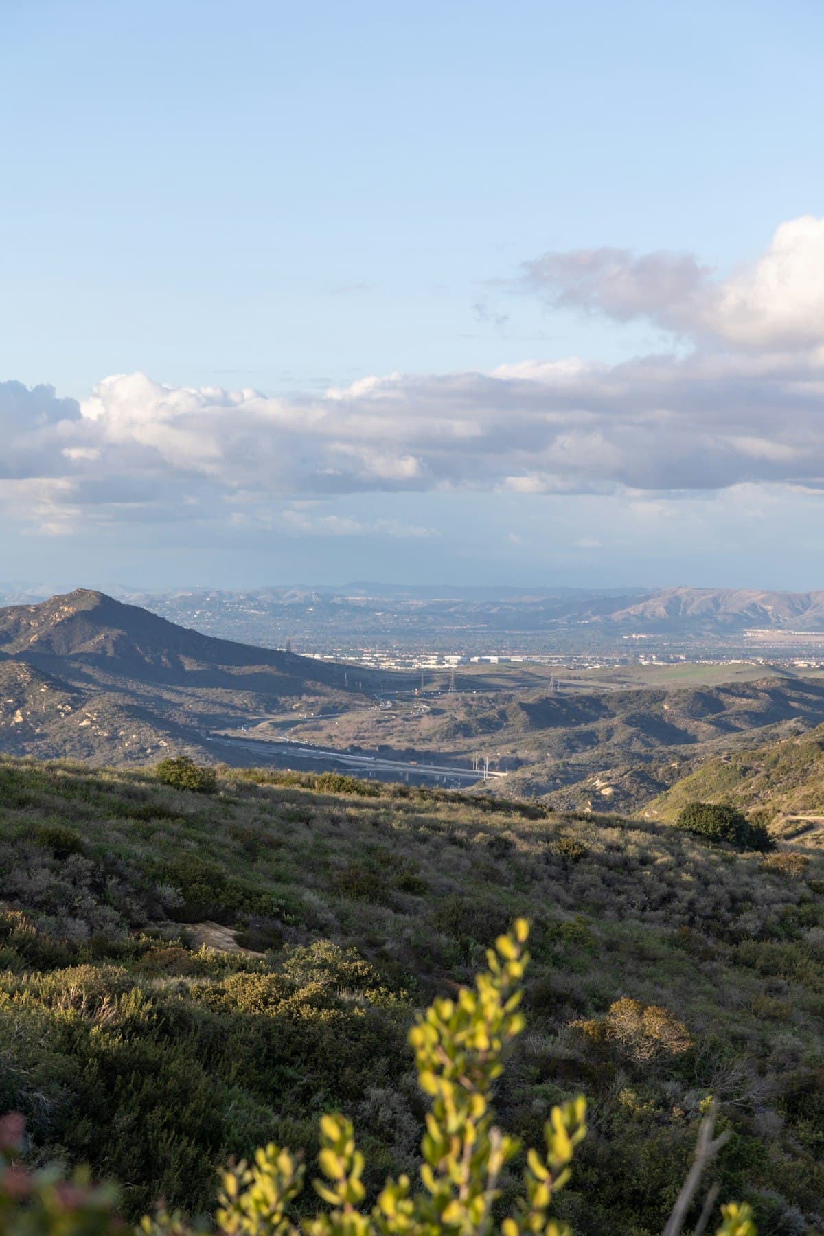 Orange County California hills and valley landscape with scattered clouds