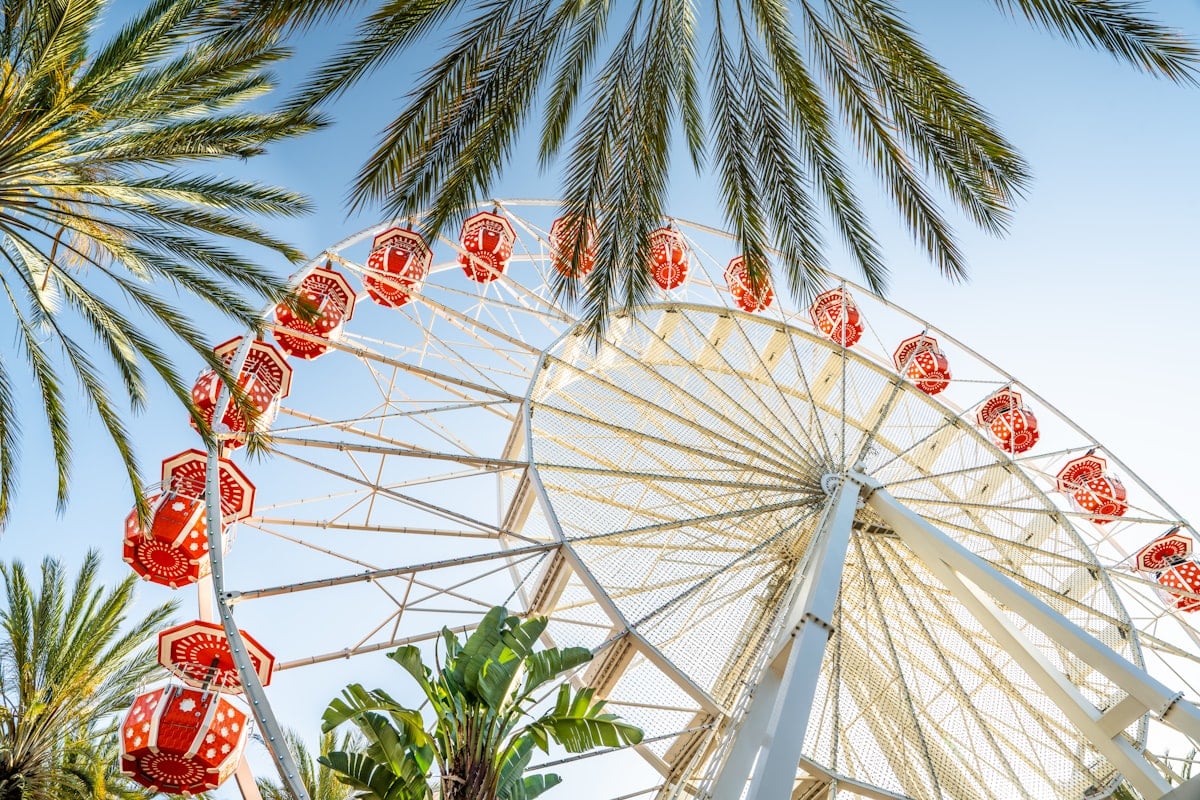 Irvine Spectrum Center ferris wheel surrounded by palm trees on a sunny day