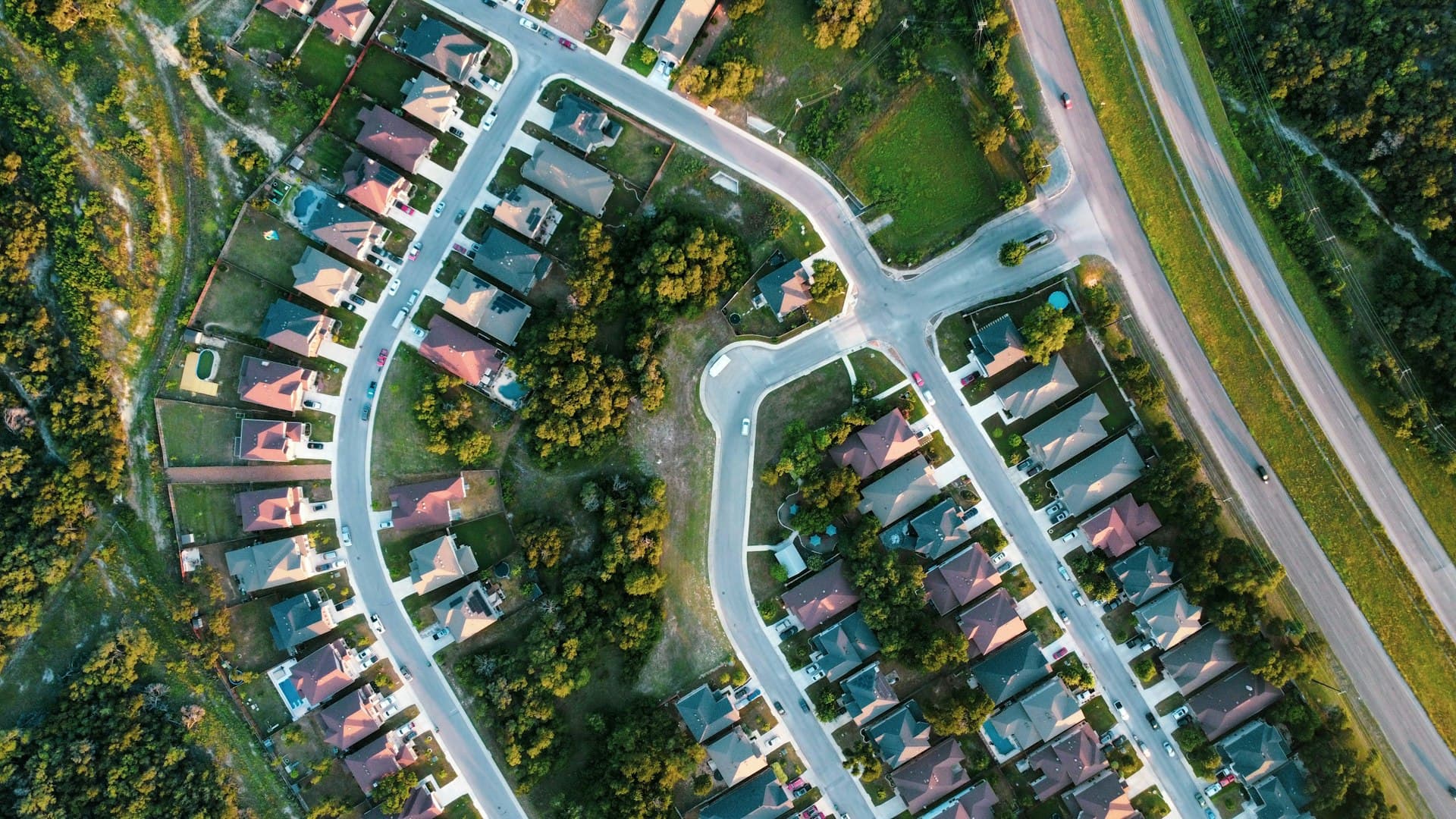 Aerial view of Texas suburban neighborhood with winding streets and residential rooftops