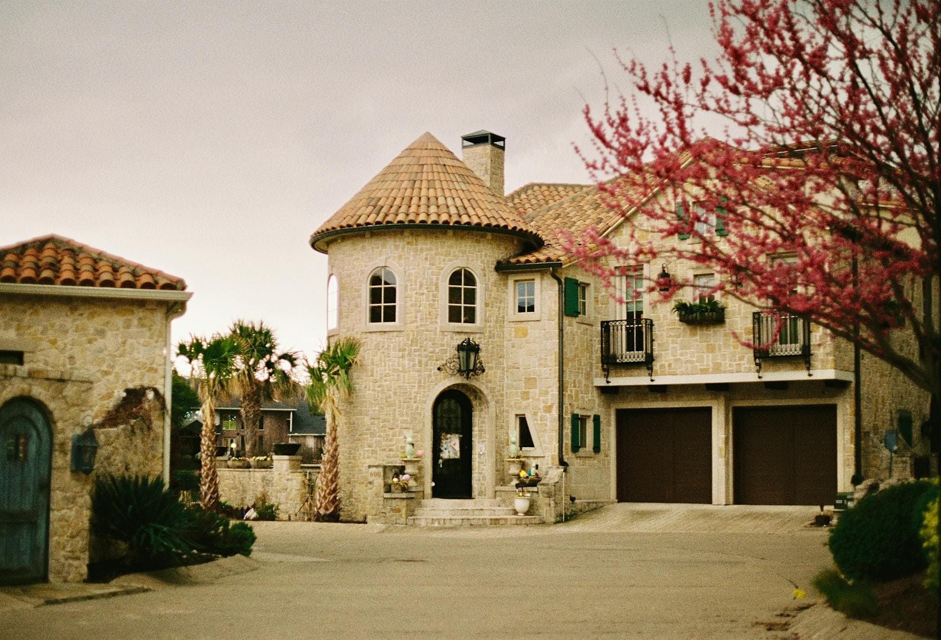 Mediterranean style stone mansion with tile roof in Dallas Texas