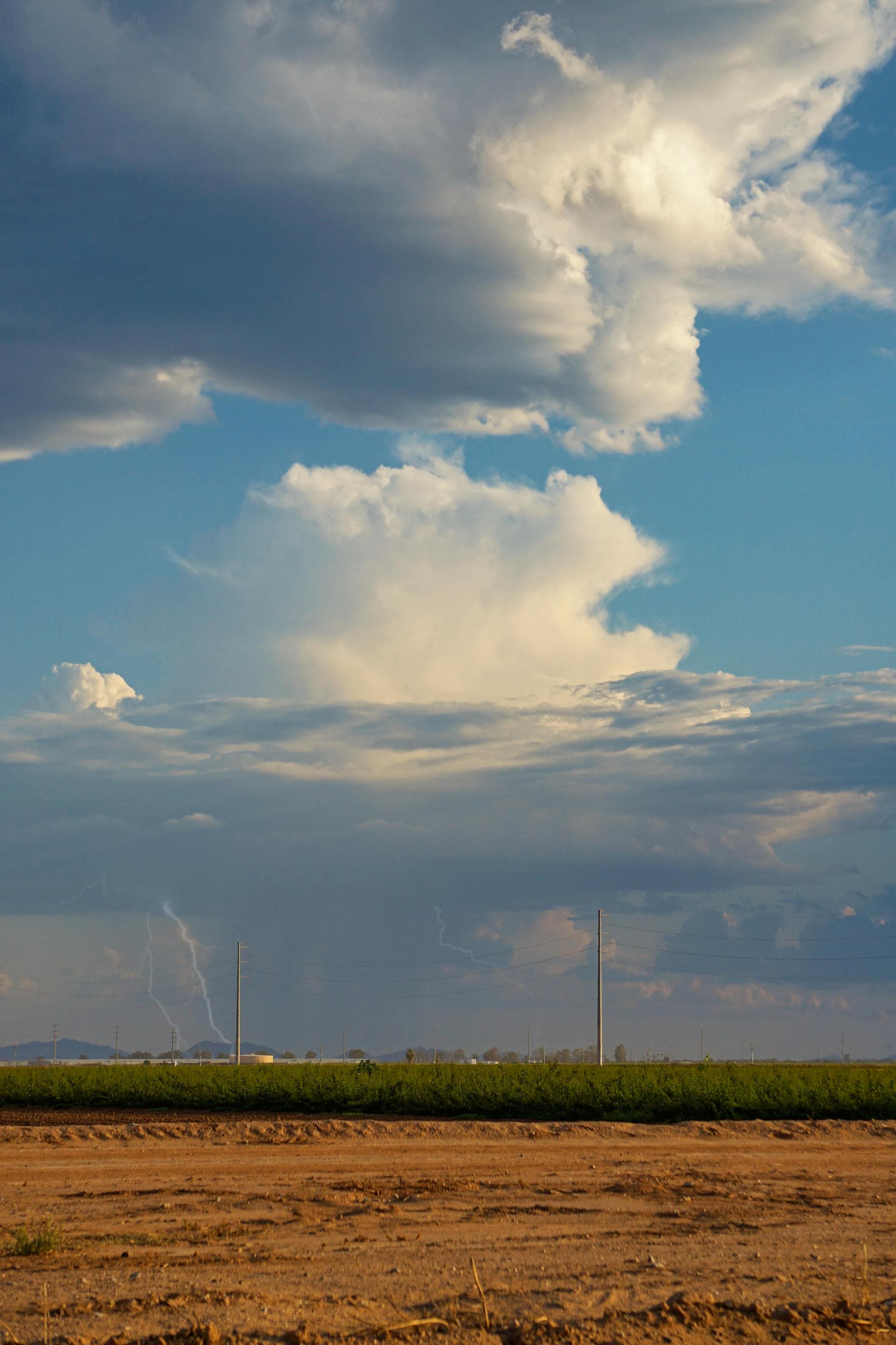 Arizona monsoon storm with dramatic clouds and lightning over desert field