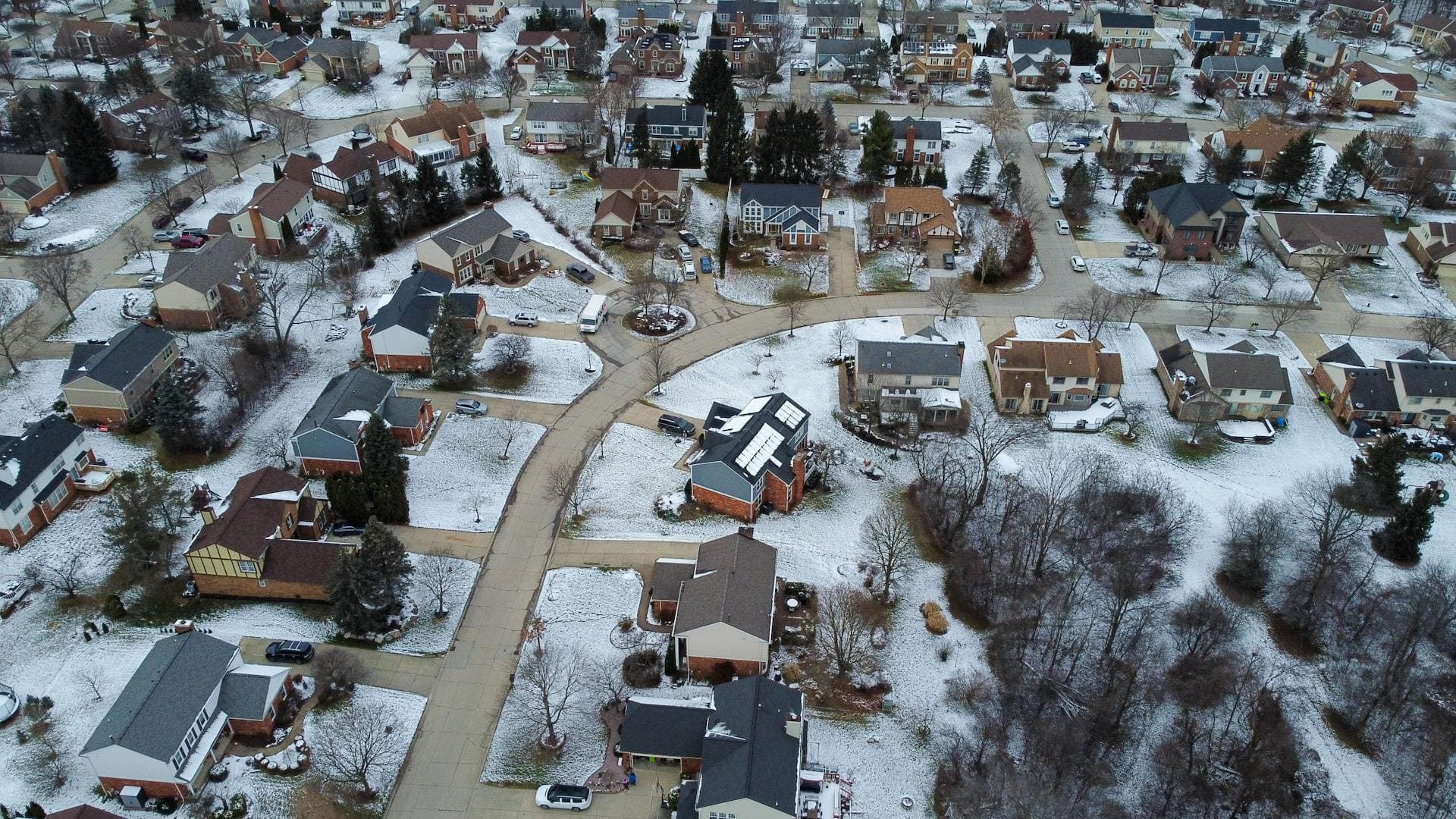 Aerial view of Midwest suburban neighborhood with snow-covered roofs in winter