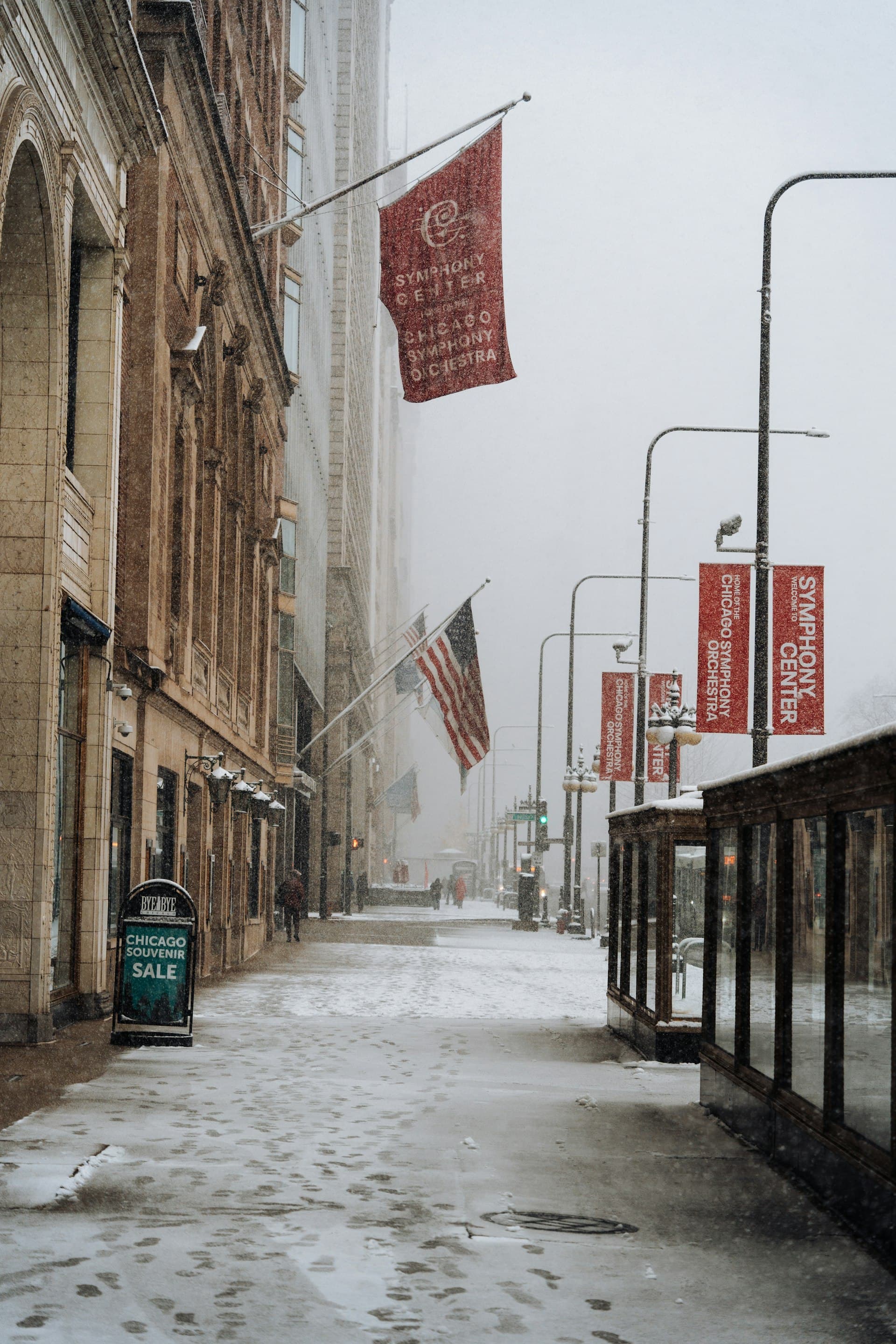 Snowy Chicago street with Symphony Center banners showing typical Midwest winter conditions