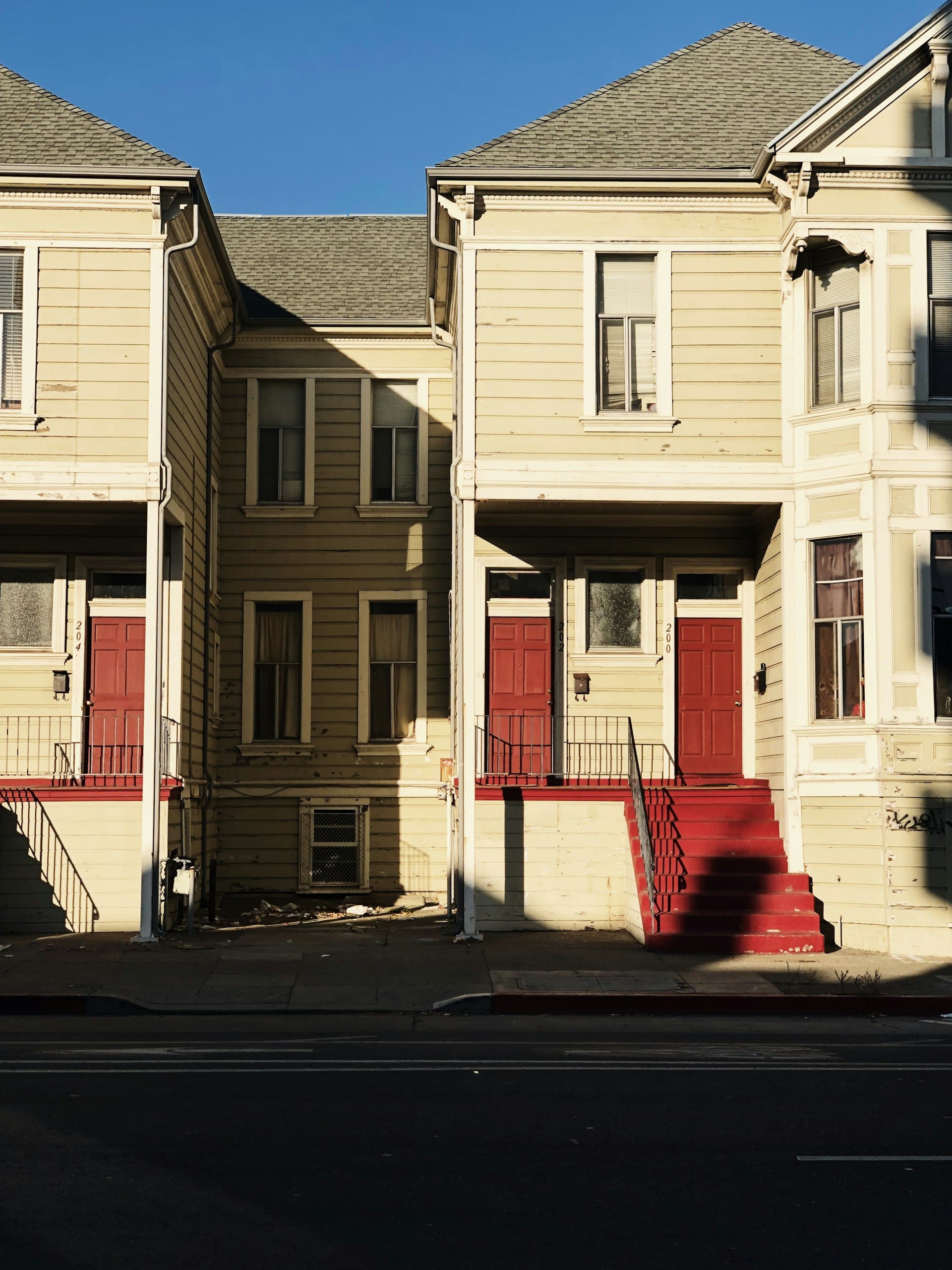 Victorian row houses with bay windows and distinctive rooflines in Oakland