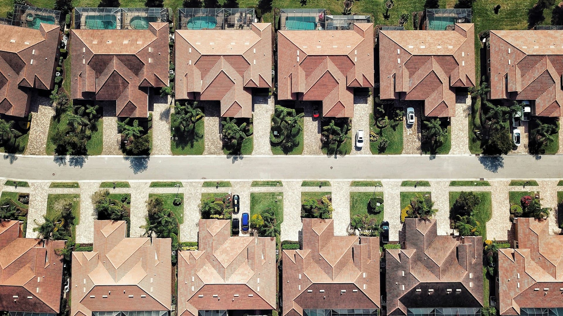 Aerial view of Florida residential neighborhood showing tile roofs and swimming pools
