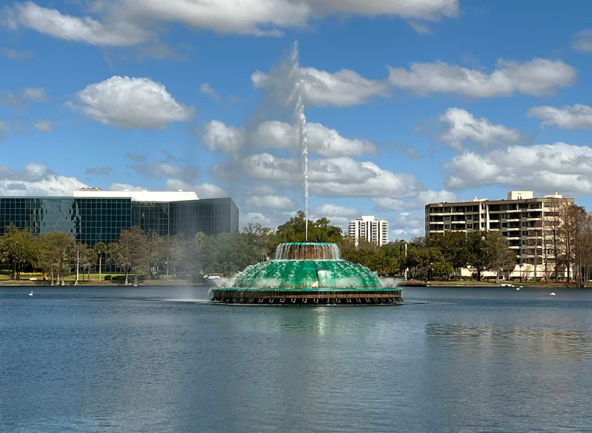 Lake Eola Fountain in downtown Orlando Florida with city buildings in background