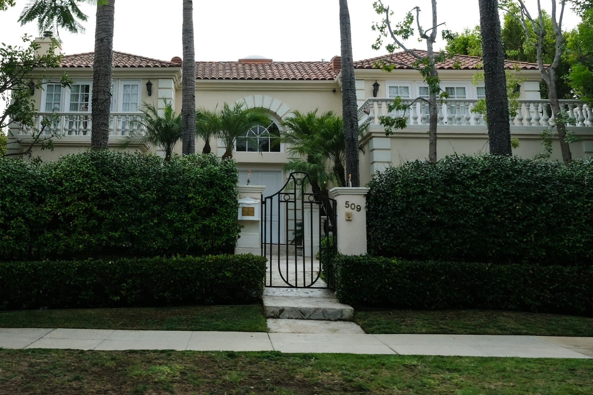 Mediterranean-style luxury home with tile roof and palm trees representative of Winter Park and Dr. Phillips neighborhoods