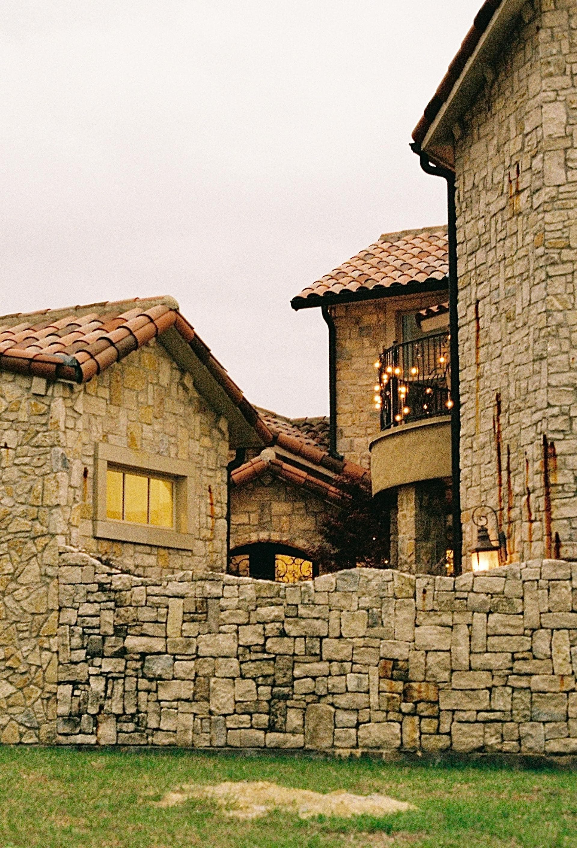 Stone mansion with tile roofing in Dallas Texas area representing luxury neighborhoods