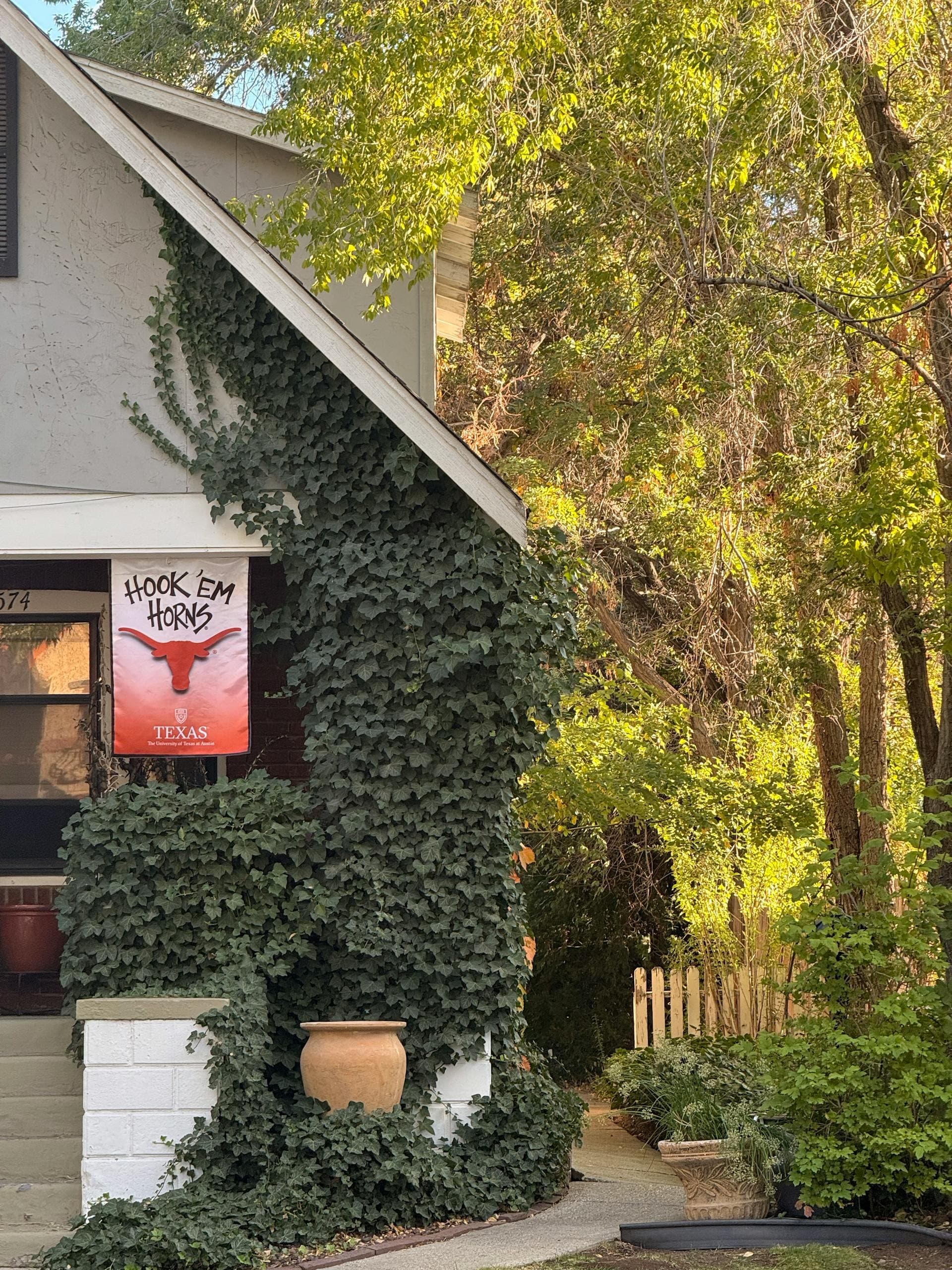 Charming residential home exterior in Reno Nevada with ivy-covered facade and mature trees