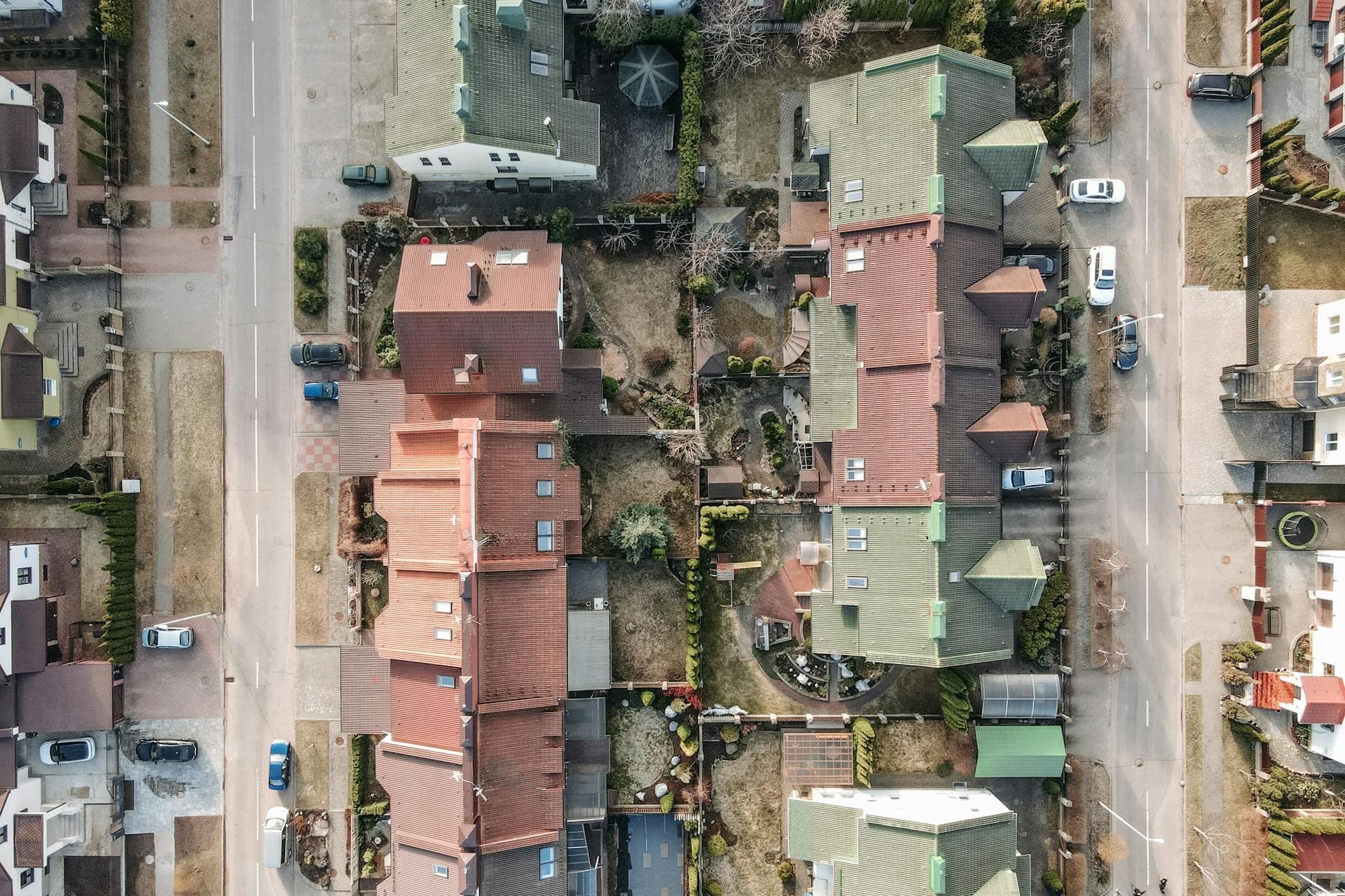 Aerial view of residential neighborhood showing various roof types and tile roofs