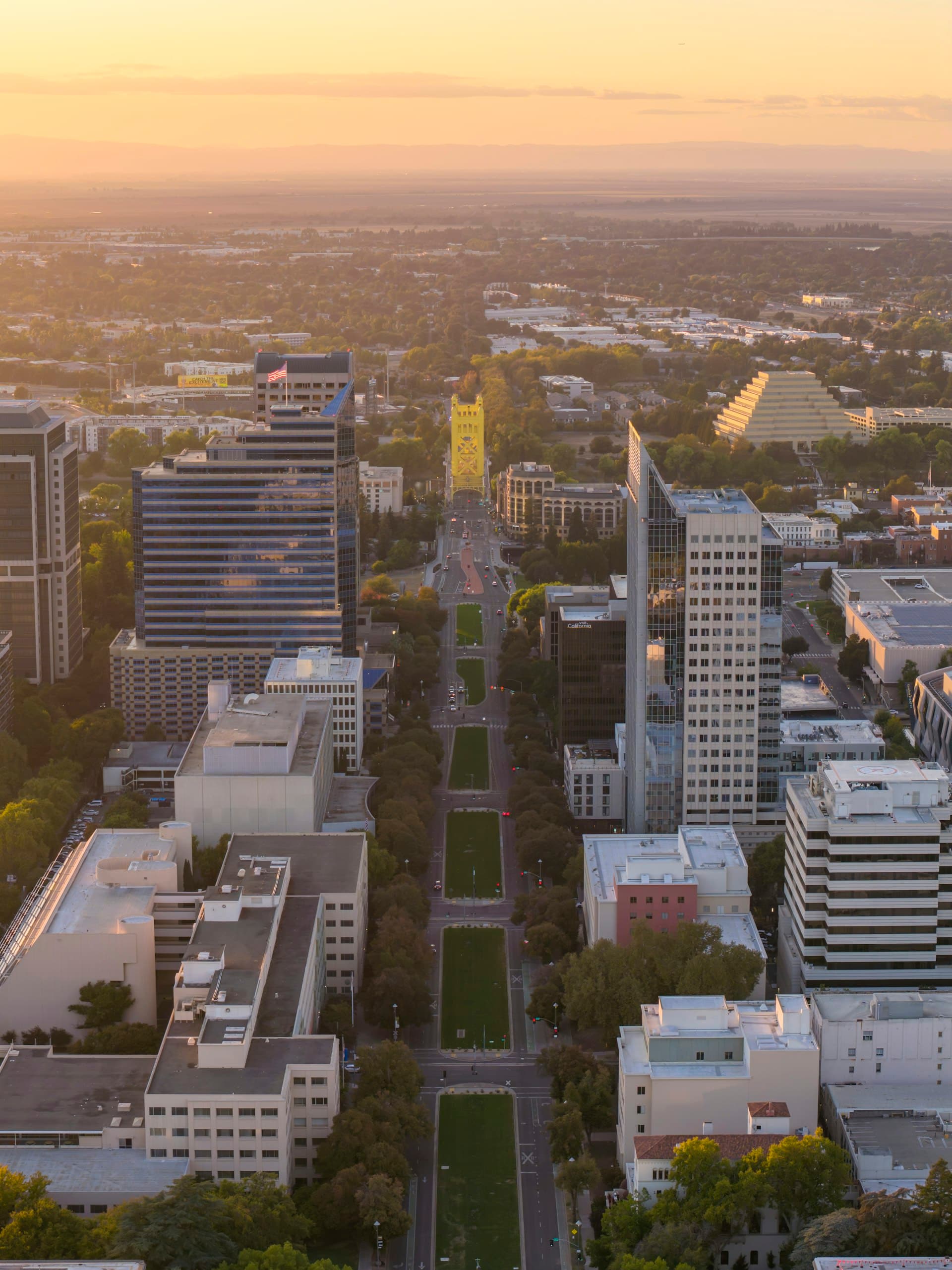 Aerial view of downtown Sacramento skyline at sunset with Capitol building visible