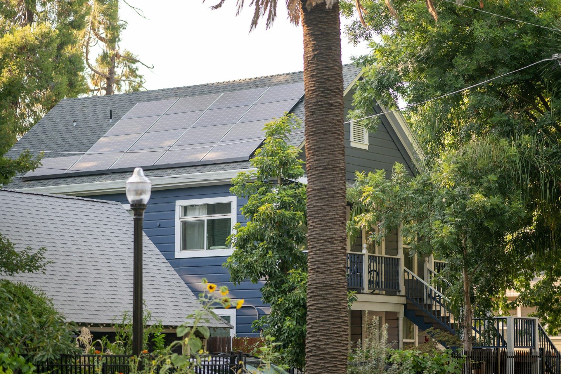Sacramento home with solar panels on roof surrounded by trees