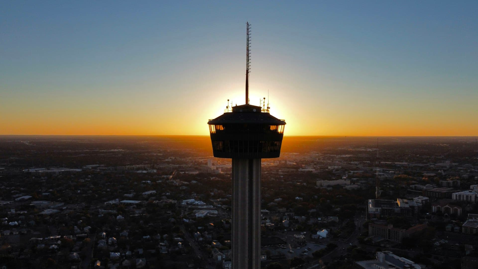 Tower of the Americas at sunset with San Antonio cityscape aerial view