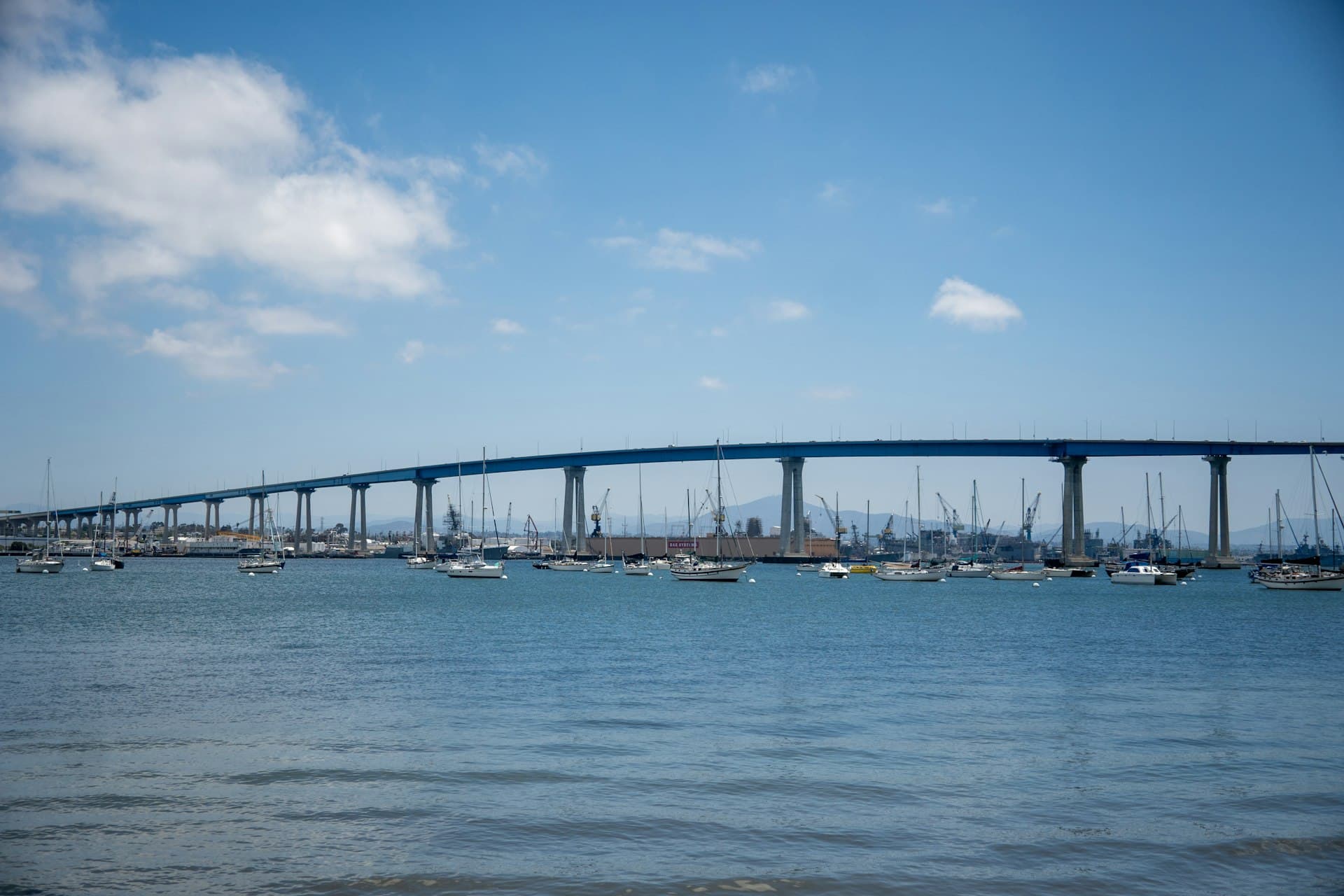 Coronado Bridge spanning San Diego Bay with sailboats in foreground