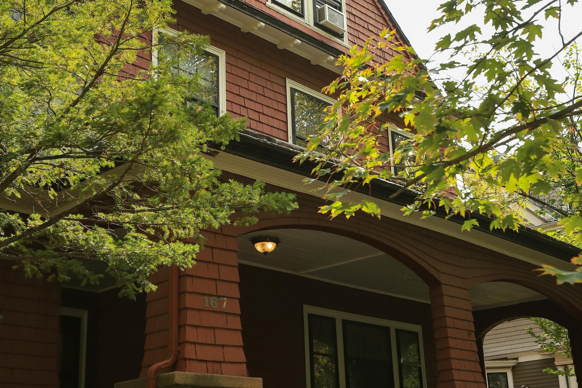 Classic Craftsman style home with covered front porch and shingle siding