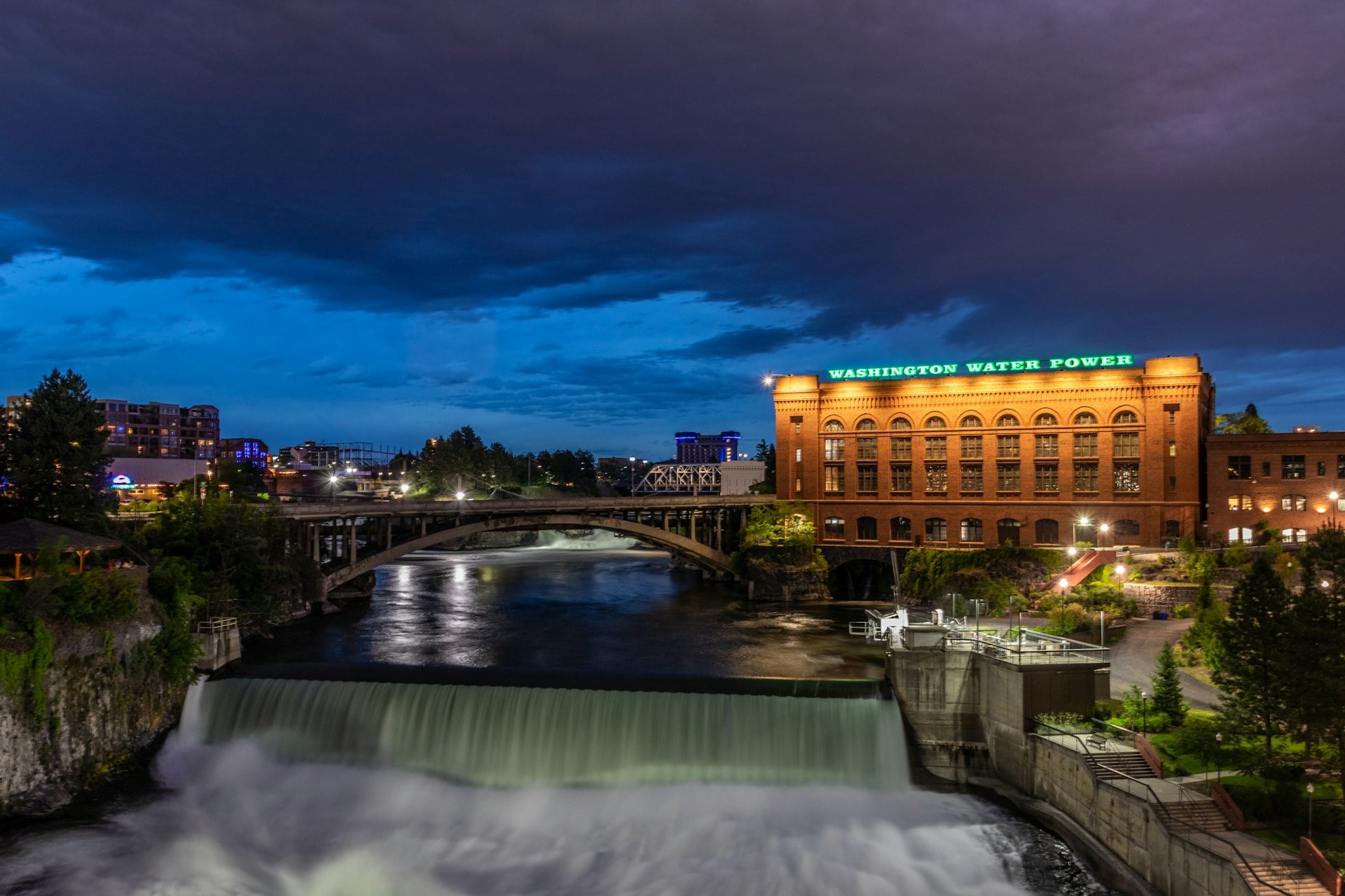 Spokane Falls and Washington Water Power building at dusk with dramatic sky