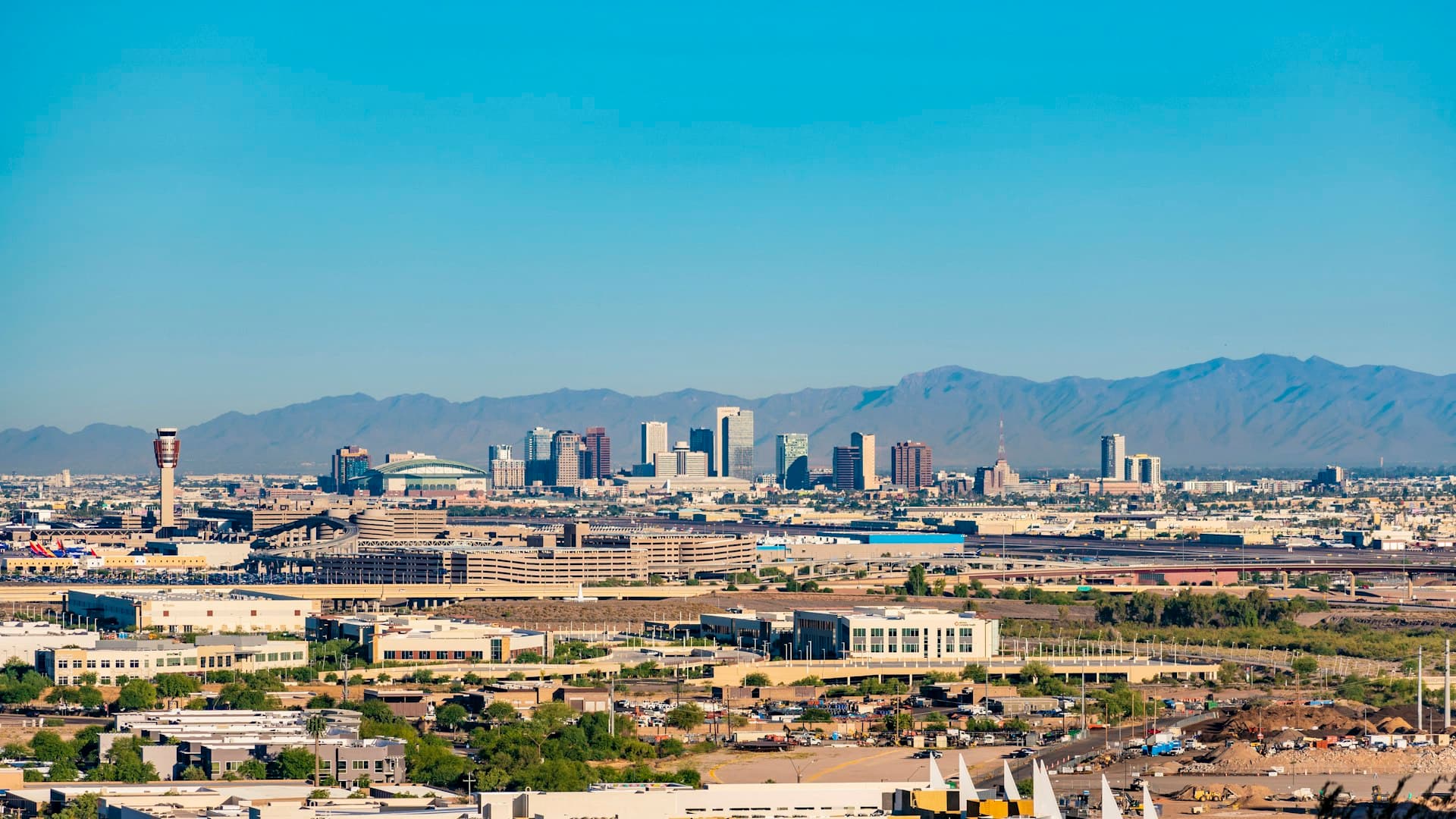 Aerial view of Tempe Arizona skyline with Phoenix metro area and mountains in background